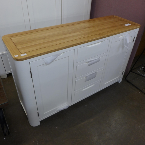 1335 - A Hove white painted and oak two door, four drawer sideboard, slight mark to the back right hand cor... 