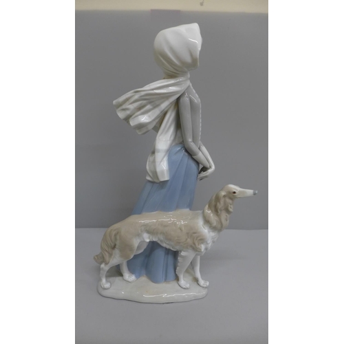 603 - A Lladro figure of a girl with Borzoi