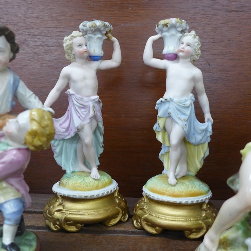 616 - A pair of continental figural candlesticks, one a/f, a Neapolitan cherub figure group and a pair of ... 