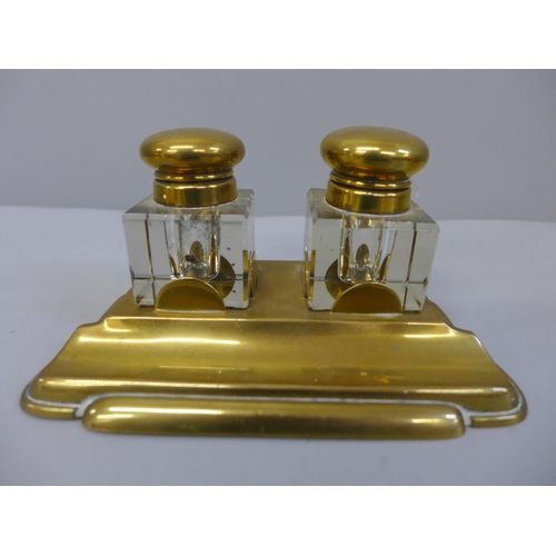 633 - A brass inkstand with a pair of glass brass topped ink bottles