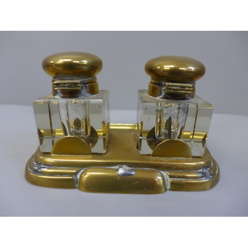 633 - A brass inkstand with a pair of glass brass topped ink bottles