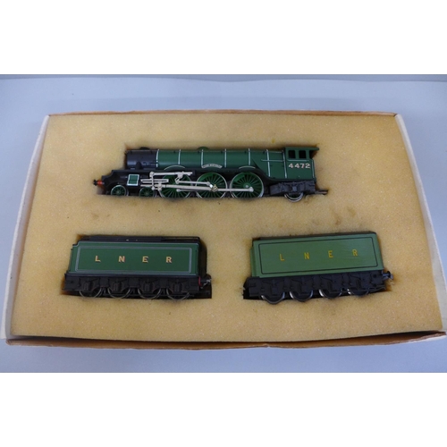 635 - A Hornby locomotive and carriage and a Trix carriage in a Trix box