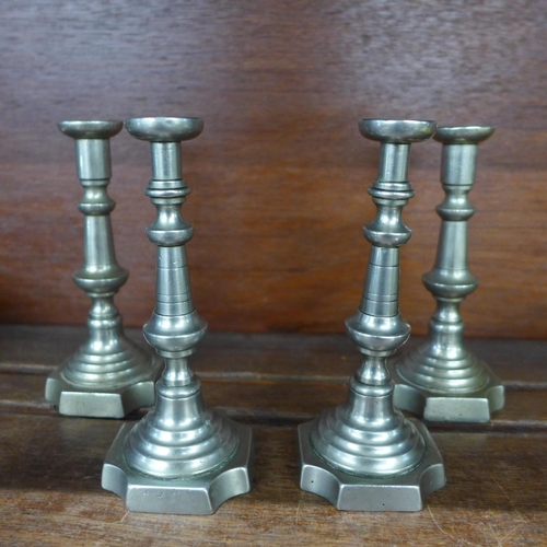 636 - A pair of silver plated and two pairs of pewter communion candlesticks