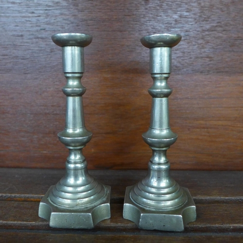 636 - A pair of silver plated and two pairs of pewter communion candlesticks