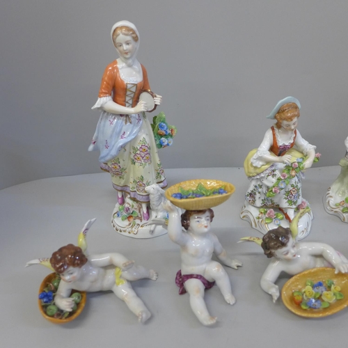 664 - A group of Sitzendorf figures, two pairs and four cherubs each with a basket of fruit