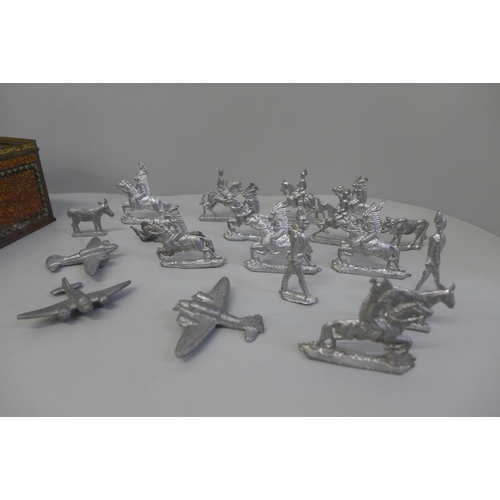 692 - A collection of metal figures, military and cowboys