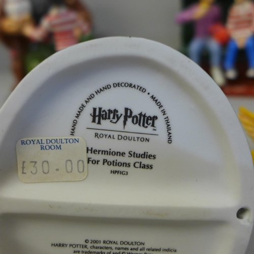 694 - Five Royal Doulton figures, Harry Potter related and a first edition Harry Potter novel