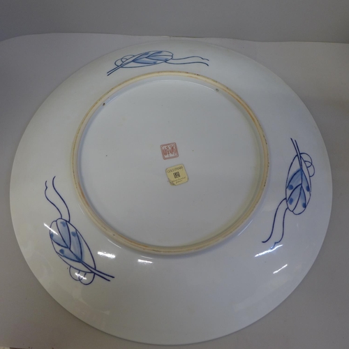 697 - An Imari charger and two biscuit barrels, one lacking lid