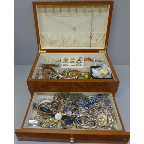 699 - A case of costume jewellery, including silver