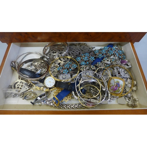 699 - A case of costume jewellery, including silver