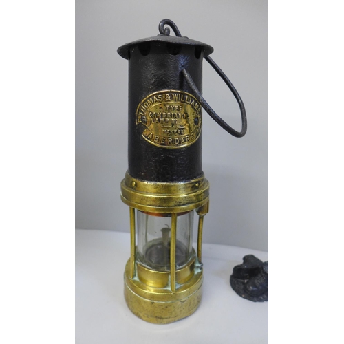 702 - A Thomas & Williams Aberdare miner's lamp, mineral samples and coal carved figures