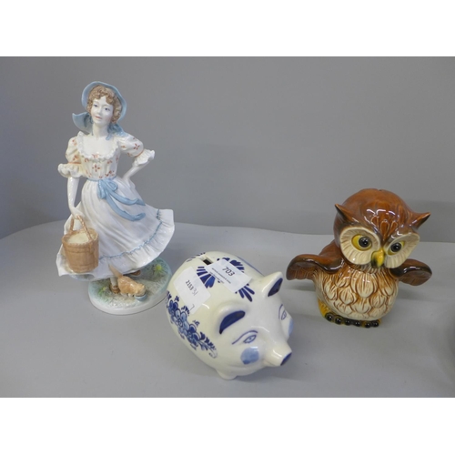 703 - A Royal Worcester figure, Delft piggy bank, Goebel money box and decorative lidded jar