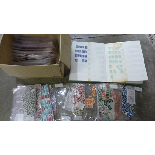 725 - Stamps; a stockbook of machins together with a duplicated stock of machins sorted into packets