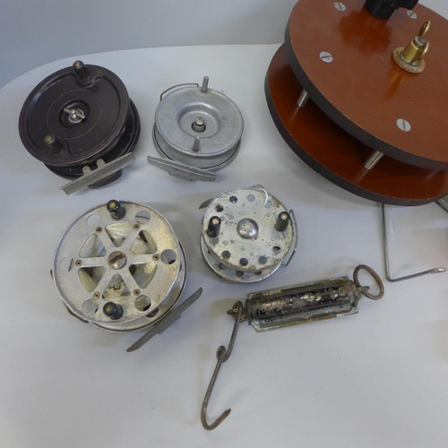 758 - A collection of fishing reels (7) and a spring balance scale