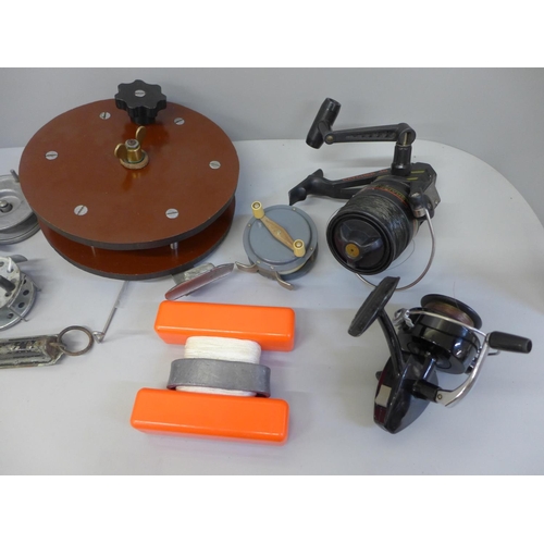 758 - A collection of fishing reels (7) and a spring balance scale