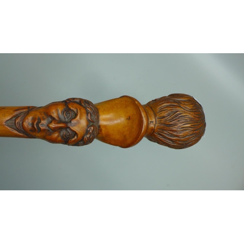 816 - A 19th Century carved fruitwood walking stick with two opposing carved heads, possibly French noblem... 