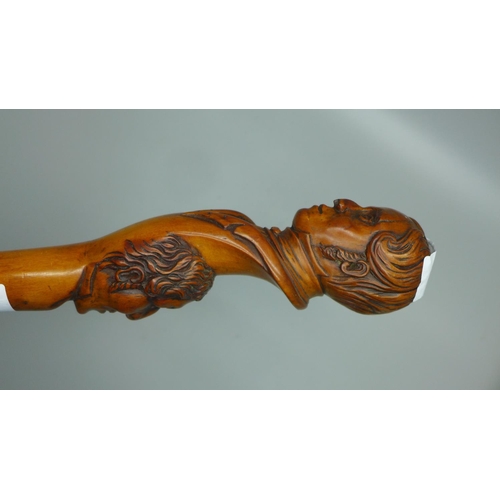 816 - A 19th Century carved fruitwood walking stick with two opposing carved heads, possibly French noblem... 