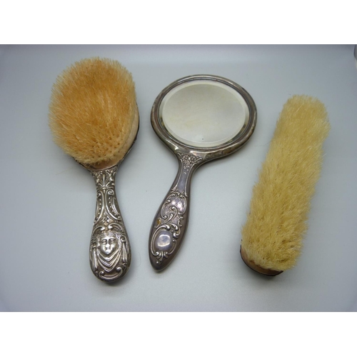 853 - Two silver backed brushes and a silver backed mirror