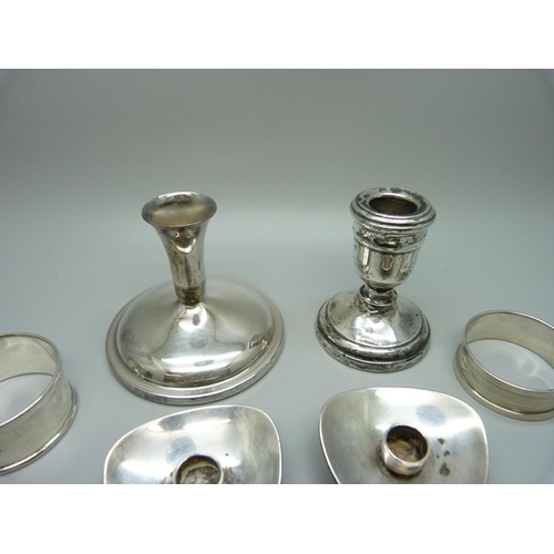 870 - Three silver napkin rings, two Danish silver candlesticks, 93g and two candlesticks and a plated pot