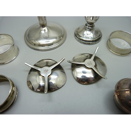 870 - Three silver napkin rings, two Danish silver candlesticks, 93g and two candlesticks and a plated pot