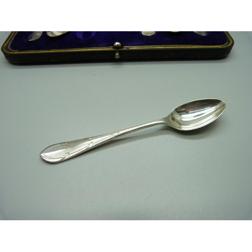 886 - A pair of silver sugar nips and six silver plated spoons, cased