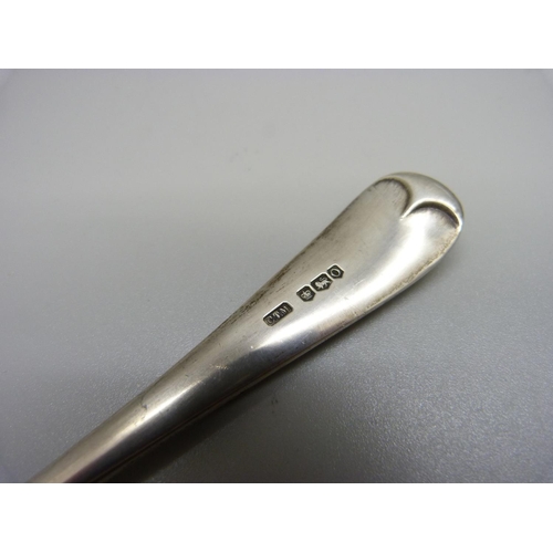 897 - A silver spoon with applied Jersey emblem, 55g