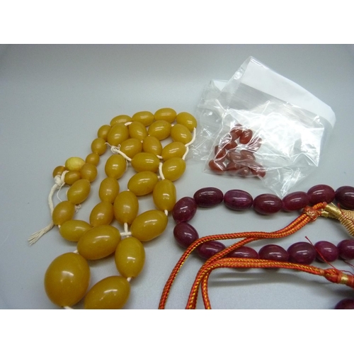 900 - Three amber style necklaces and loose beads