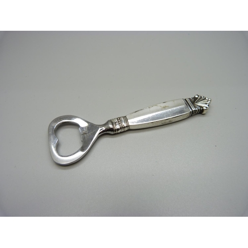 923 - A Georg Jensen silver hand bottle opener, Acanthus pattern