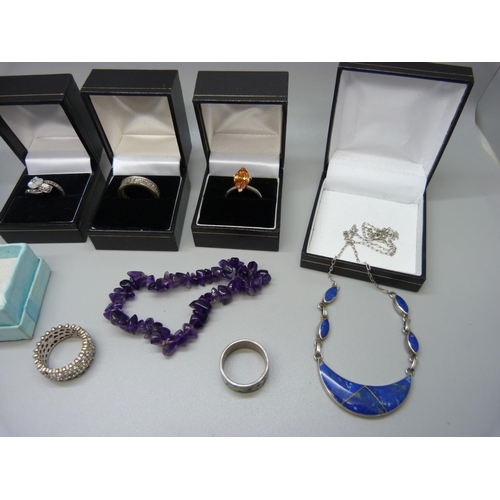 944 - Six silver rings, two silver pendants and chains, an amethyst stone bracelet and a silver bangle