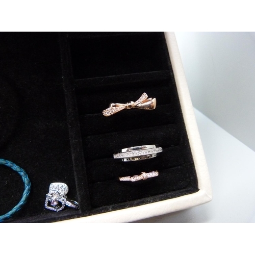 954 - A collection of Pandora jewellery, rings, charms and a present holder