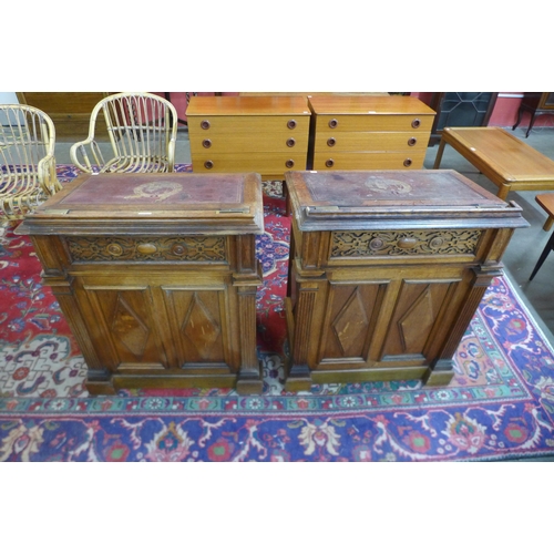 103 - A pair of Victorian Gothic Revival oak clerks desks, the gilt tooled red leather tops inset with Lat... 