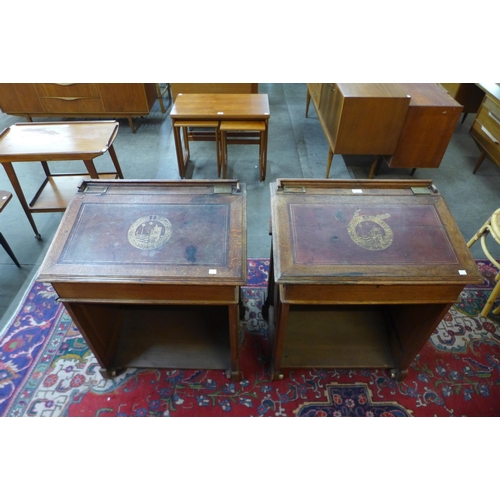 103 - A pair of Victorian Gothic Revival oak clerks desks, the gilt tooled red leather tops inset with Lat... 