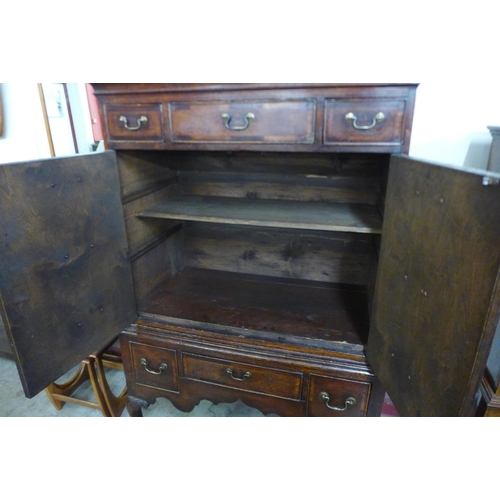 106 - A George I oak cupboard on stand