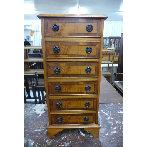 118 - A small yew wood chest of drawers