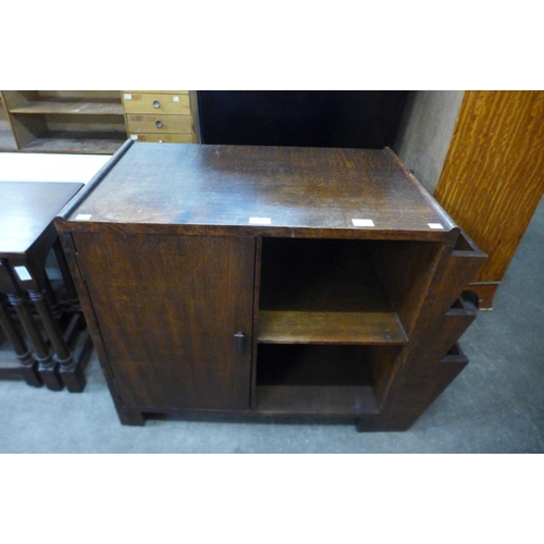 169 - An Art Deco oak cabinet/newspaper stand