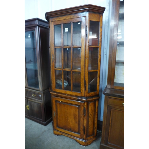 175 - An oak and elm freestanding corner cabinet