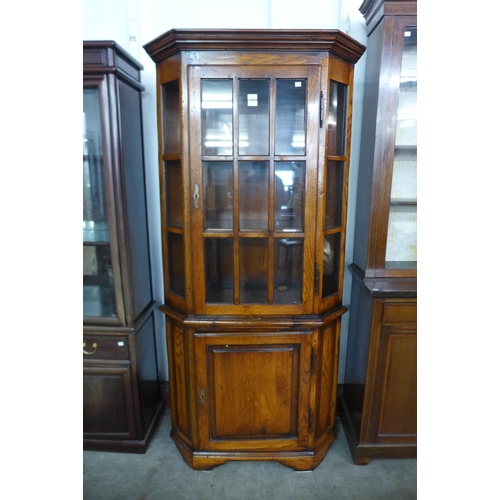 175 - An oak and elm freestanding corner cabinet