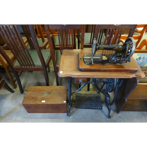 201 - An early 20th Century oak and cast iron Eclipse treadle sewing machine