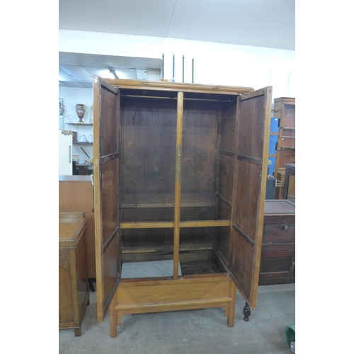 208 - A Chinese softwood two door wardrobe