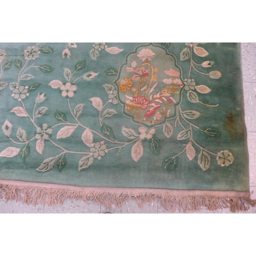 210 - A large Chinese green ground rug, 355 x 275cms