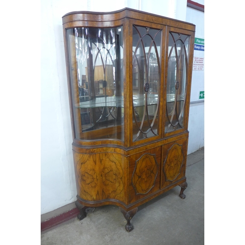 225 - A Queen Anne style figured walnut serpentine side cabinet