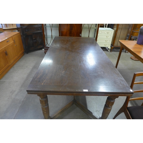 232 - A 17th Century style carved oak extending refectory table