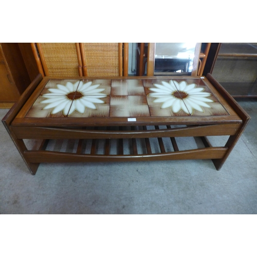 71 - A teak and tiled top coffee table