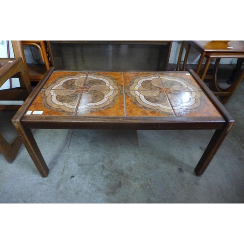 72 - A teak and tiled top coffee table