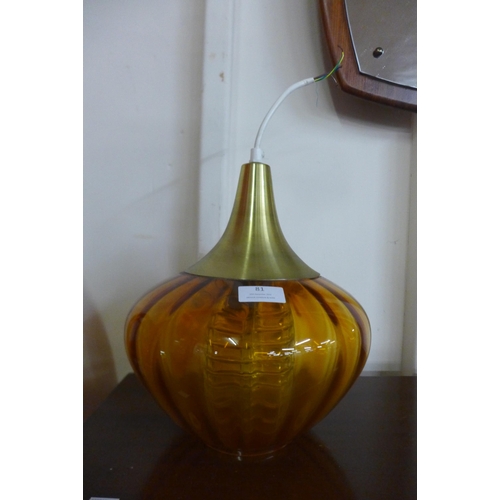 81 - An amber glass onion shaped ceiling light