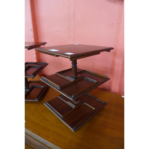 85 - A pair of mahogany revolving desk stands, 30cms h