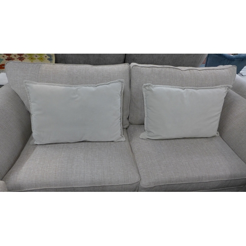 1354 - An oatmeal upholstered three seater sofa and armchair - RRP £1898