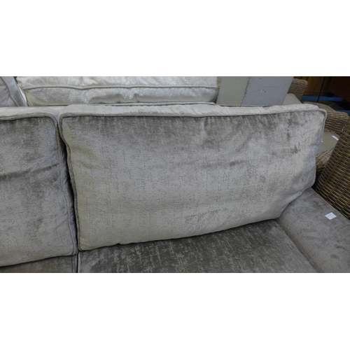 1352 - A mink velvet three seater sofa on chrome castors