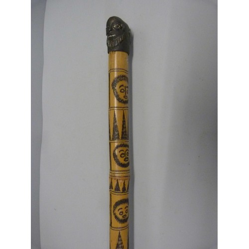 819 - A bamboo walking cane decorated with carved bearded heads