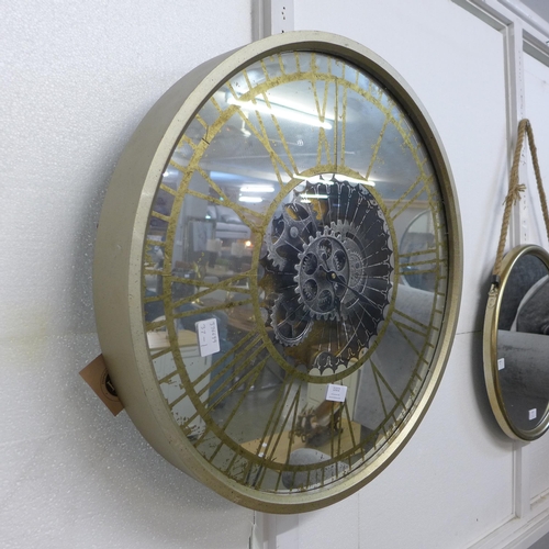 1322 - A mirrored round clock showing moving mechanism (18570)   *